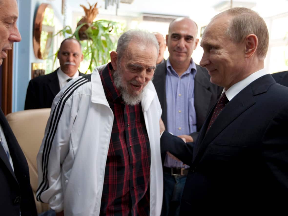 Cuba's Fidel Castro, centre, meets with Russia's President Vladimir Putin, right, in Havana, Cuba on July 11, 2014. Castro died in 2016 but the Kremlin's efforts to keep Cuba in its corner have only intensified since it invaded Ukraine. (Alex Castro/The Associated Press - image credit)
