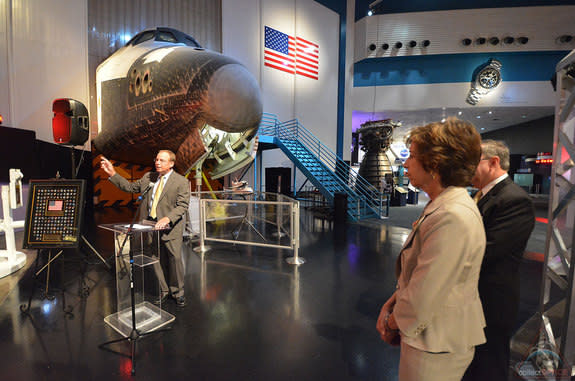 — Scott Hartwig, president and CEO of United Space Alliance (USA), speaks at his company's space shuttle pin presentation ceremony as Ellen Ochoa, NASA Johnson Space Center director, and Richard Allen, Space Center Houston president and CEO, lo