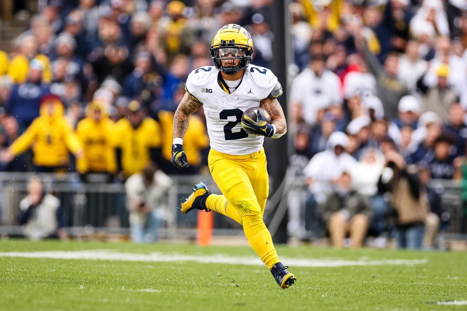 Blake Corum of the Michigan Wolverines carries the ball against the Penn State Nittany Lions during the first half at Beaver Stadium on November 11, 2023 in State College, Pennsylvania.