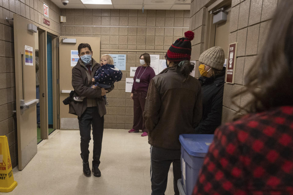 Mayor Jacob Frey casts his vote on Election Day alongside his family at the Marcy Arts Magnet Elementary School on Tuesday, Nov. 2, 2021 in Minneapolis. Voters in Minneapolis are deciding whether to replace the city’s police department with a new Department of Public Safety. The election comes more than a year after George Floyd’s death launched a movement to defund or abolish police across the country. (AP Photo/Christian Monterrosa)