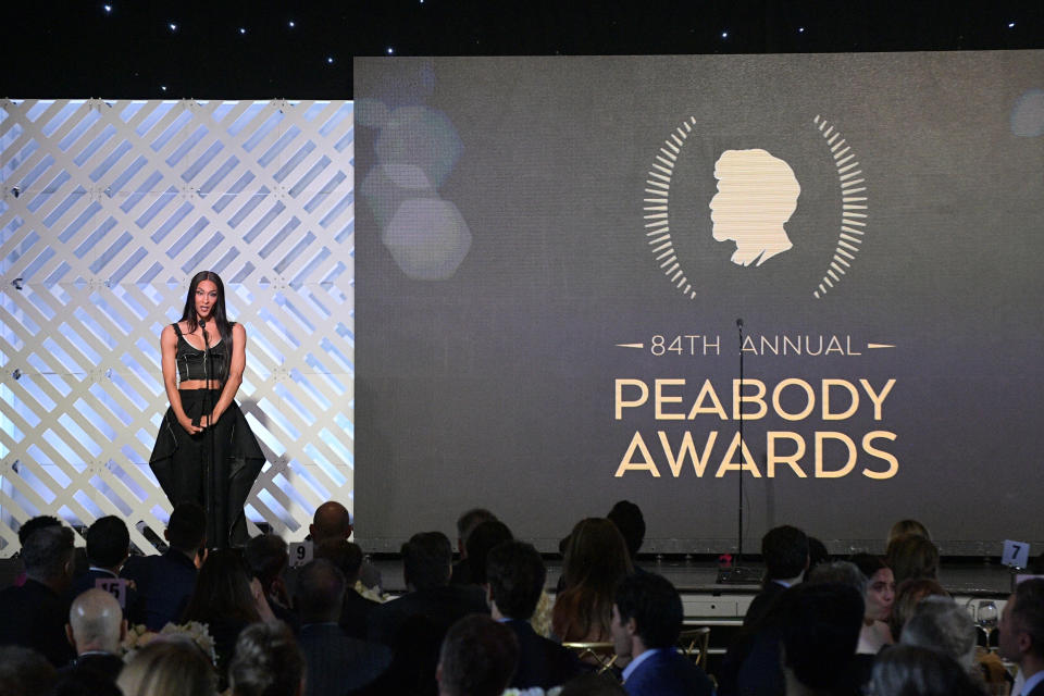 Michaela Jaé Rodriguez speaks onstage during the 2024 Peabody Awards at Beverly Wilshire in pointed-toe pumps