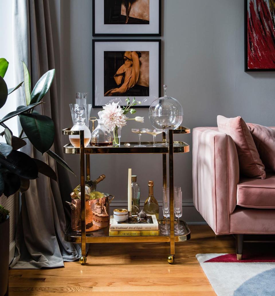 The brass bar cart, which was on Natasha’s must list for her new place, adds to the glamorous palette.