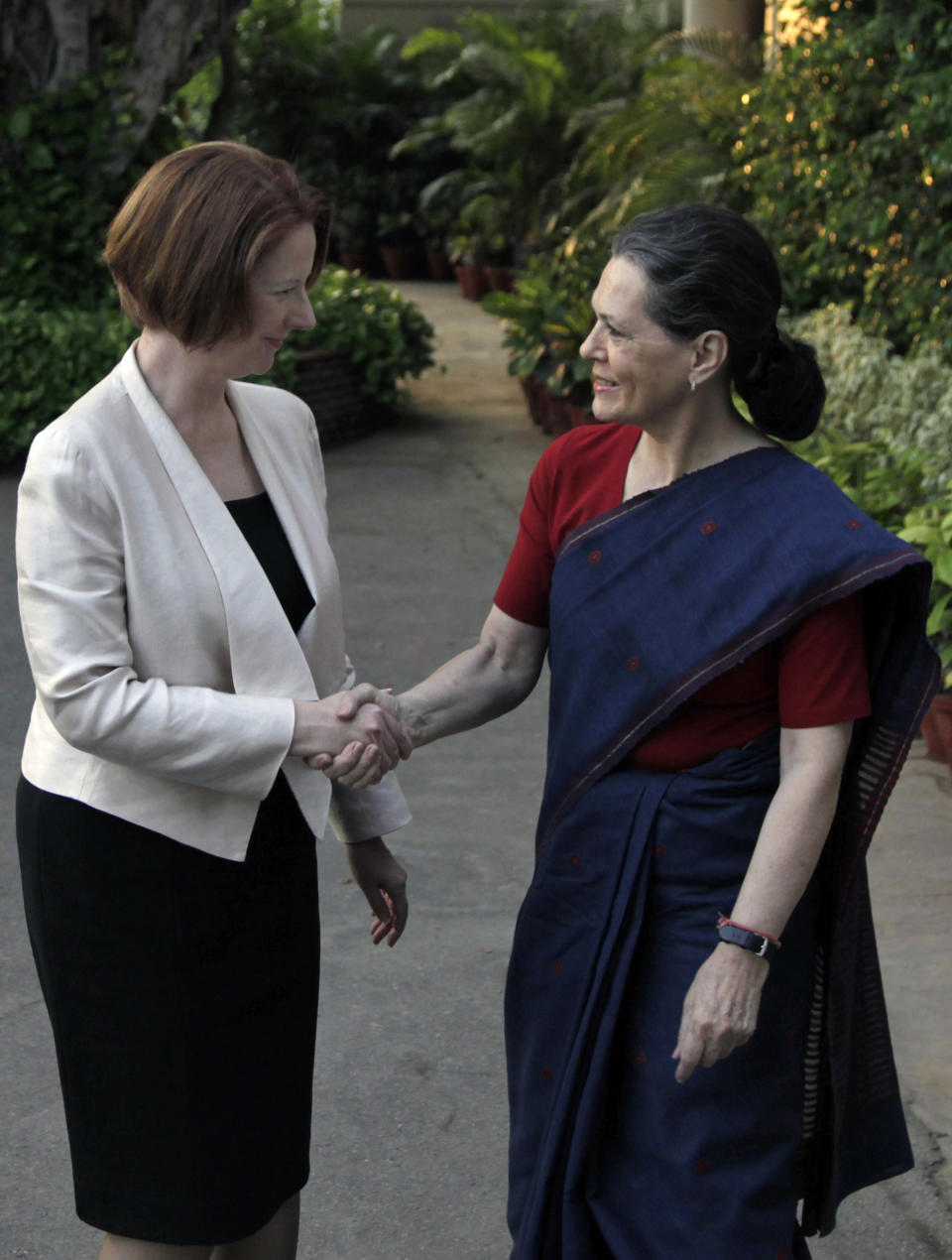Australian Prime Minister Julia Gillard, left, shakes hands with India's Congress Party president Sonia Gandhi, at the latter's residence before a meeting in New Delhi, India, Wednesday, Oct. 17, 2012. India and Australia began talks Wednesday to strengthen economic and strategic ties and explore cooperation in civilian nuclear energy. (AP Photo/ Mustafa Quraishi)