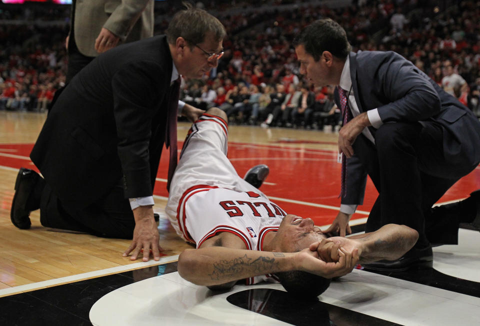 CHICAGO, IL - APRIL 28: Derrick Rose #1 of the Chicago Bulls is examined after suffering an injury against the Philadelphia 76ers in Game One of the Eastern Conference Quarterfinals during the 2012 NBA Playoffs at the United Center on April 28, 2012 in Chicago, Illinois. The Bulls defeated the 76ers 103-91. NOTE TO USER: User expressly acknowledges and agrees that, by downloading and or using this photograph, User is consenting to the terms and conditions of the Getty Images License Agreement. (Photo by Jonathan Daniel/Getty Images)