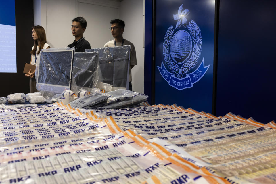 Evidence are displayed by police for media after police arrested six people following allegations of fraud at an unlicensed cryptocurrency exchange in Hong Kong, Tuesday, Sept. 19, 2023. (AP Photo/Louise Delmotte)