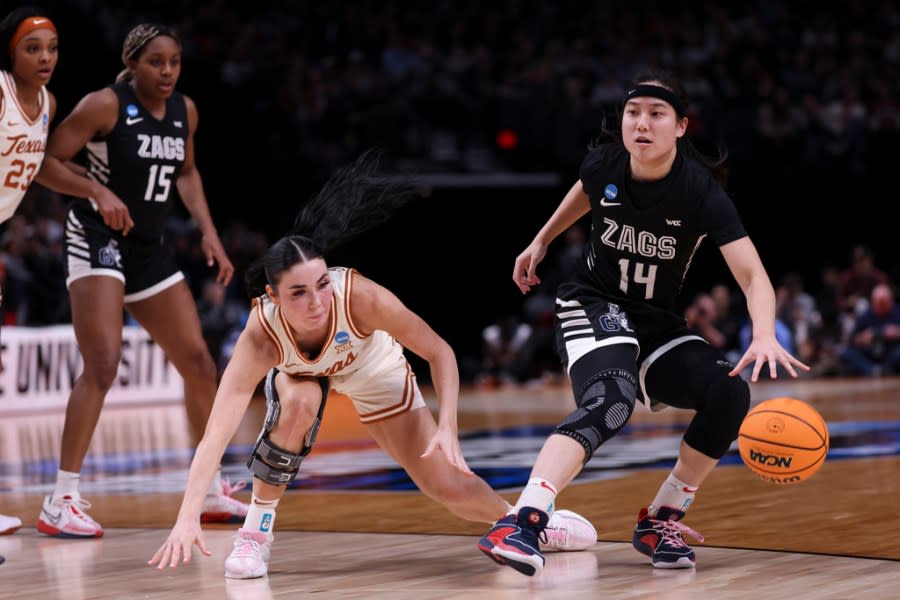 Gonzaga guard Kaylynne Truong (14) dribbles the ball as Texas guard Shaylee Gonzales defends during the first half of a Sweet 16 college basketball game in the women’s NCAA Tournament, Friday, March 29, 2024, in Portland, Ore. (AP Photo/Howard Lao)