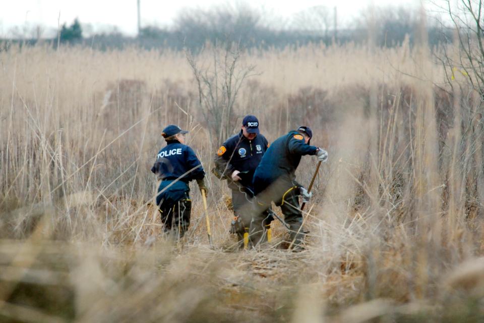 Crime scene investigators search a marsh for the remains of the Gilgo Beach serial murder victims.