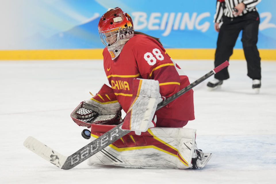 China goalkeeper Tiya Chen blocks a shot against Czech Republic during a preliminary round women's hockey game at the 2022 Winter Olympics, Thursday, Feb. 3, 2022, in Beijing. (AP Photo/Petr David Josek)