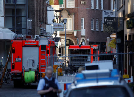 Police vehicles and fire engines in a street near a place where a man drove a van into a group of people sitting outside a popular restaurant in the old city centre of Muenster, Germany, April 7, 2018. REUTERS/Leon Kuegeler