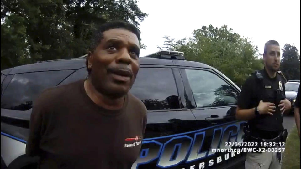 This image captured from bodycam video released by the Childersburg (Ala.) Police Department and provided by attorney Harry Daniels shows Michael Jennings, left, in custody in Childersburg, Ala., on Sunday, May 22, 2022. Jennings was helping out a friend by watering flowers when officers showed up and placed him under arrest within moments. (Childersburg Police Department via AP)