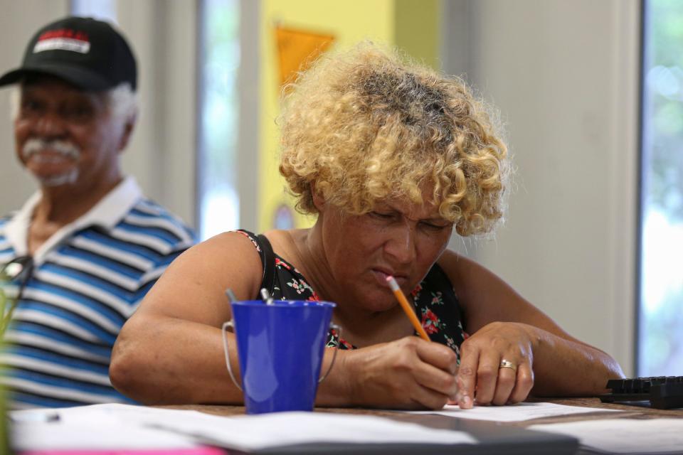 Esther Cepeda fills out a form to receive food from a new food pantry at the Boys and Girls Club of Port St. Lucie County on Thursday, Sept. 15, 2022. The food pantry, named the CHU Pantry, is available for club parents who may need items to fulfill their grocery gap. Fruits, vegetables, proteins, dairy products and starches are available upon request for the club members. 