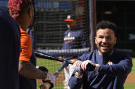 Houston Astros second baseman Jose Altuve, right, jokes with catcher Martin Maldonado during a practice ahead of Game 1 of baseball's American League Championship Series, in Houston, Tuesday, Oct. 18, 2022. (AP Photo/Eric Gay)