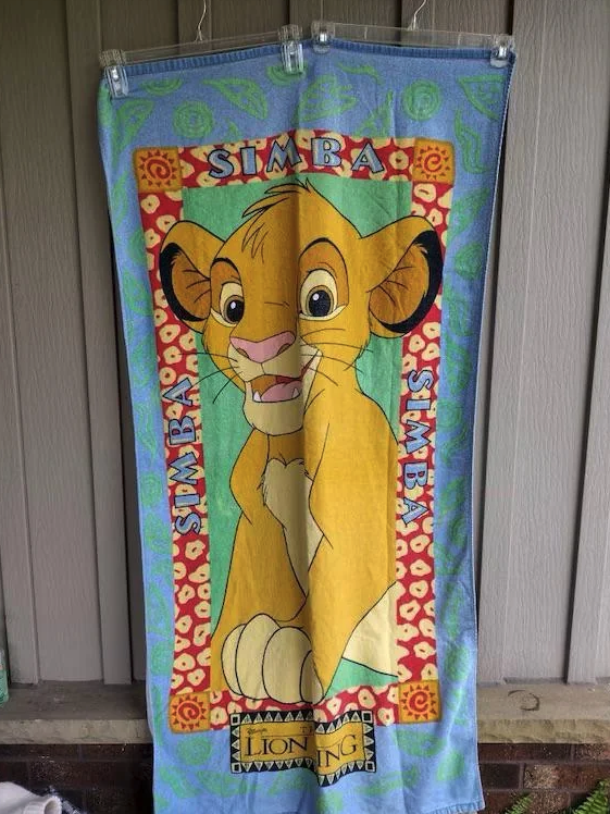 Towel featuring Simba from "The Lion King," with his name repeated around the border