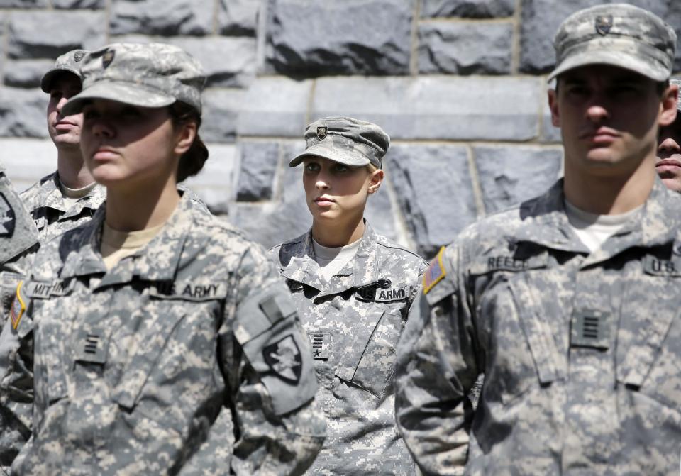 In this April 9, 2014 photo, West Point cadet Austen Boroff, center, of Chatham, N.J., stands in formation as she waits to march to lunch at the United States Military Academy in West Point, N.Y. With the Pentagon lifting restrictions for women in combat jobs, Lt. Gen. Robert Caslen Jr. has set a goal of boosting the number of women above 20 percent for the new class reporting this summer. (AP Photo/Mel Evans)