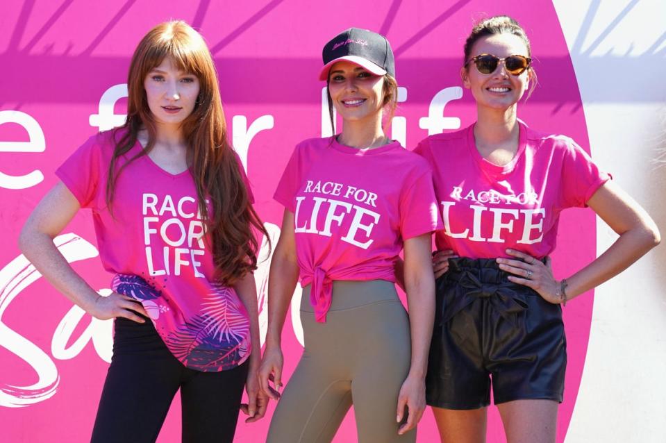 Nicola Roberts, Cheryl Tweedy, and Nadine Coyle took part in a Race For Life in Sarah Harding’s honour (PA)