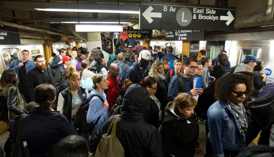 Commuters work their way across a crowded subway platform in New York.