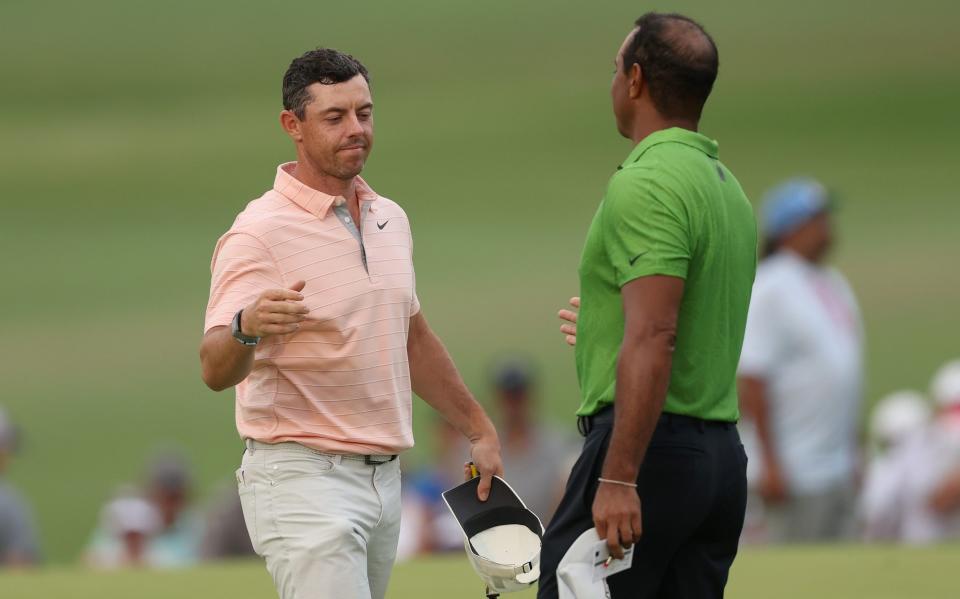 Tiger Woods and Rory McIlroy shake hands - GETTY IMAGES