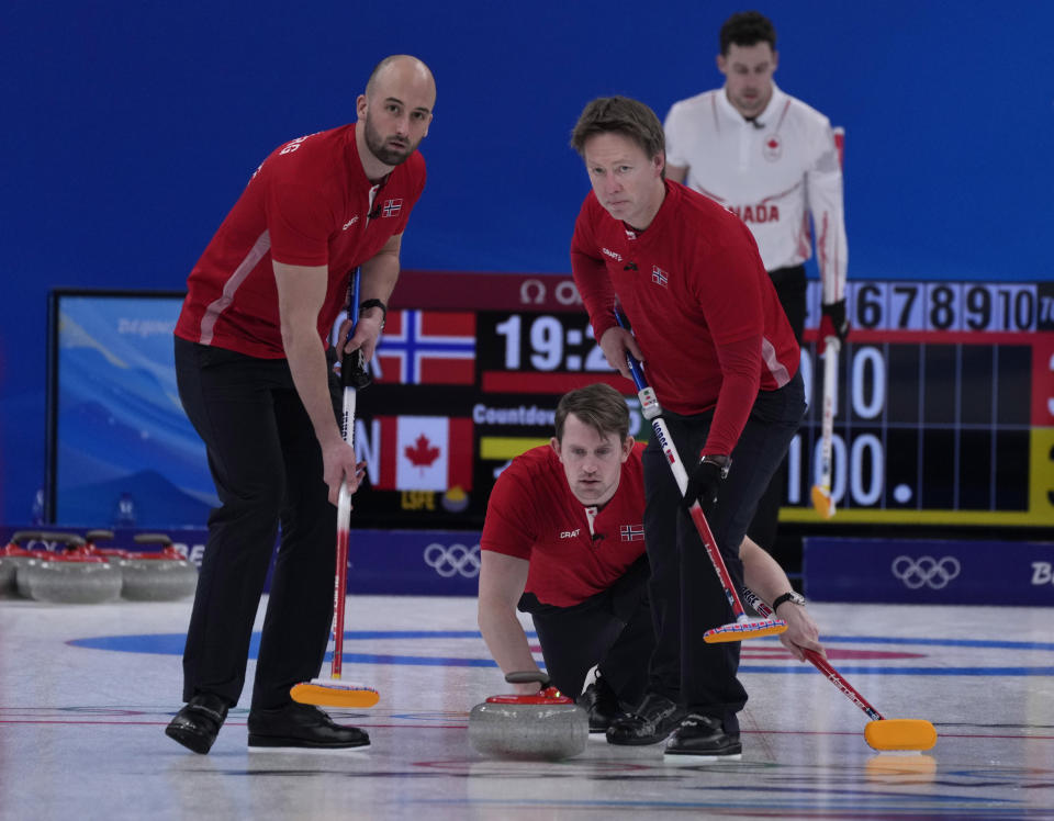 Norway's Magnus Vaagberg, throws a rock, during the men's curling match against Canada, at the 2022 Winter Olympics, Thursday, Feb. 10, 2022, in Beijing. (AP Photo/Nariman El-Mofty)