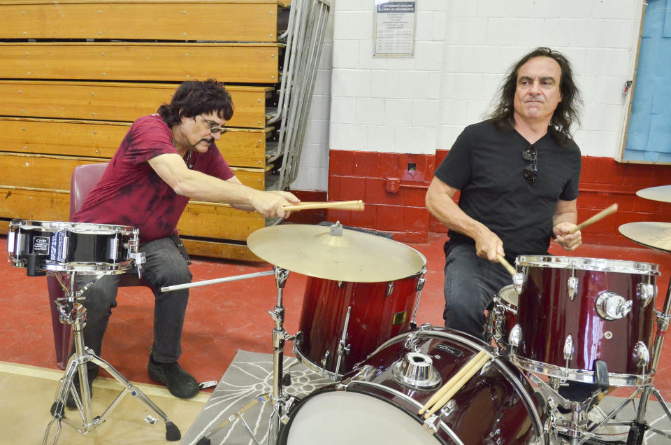 Brothers Carmine and Vinny Appice share a drum set.