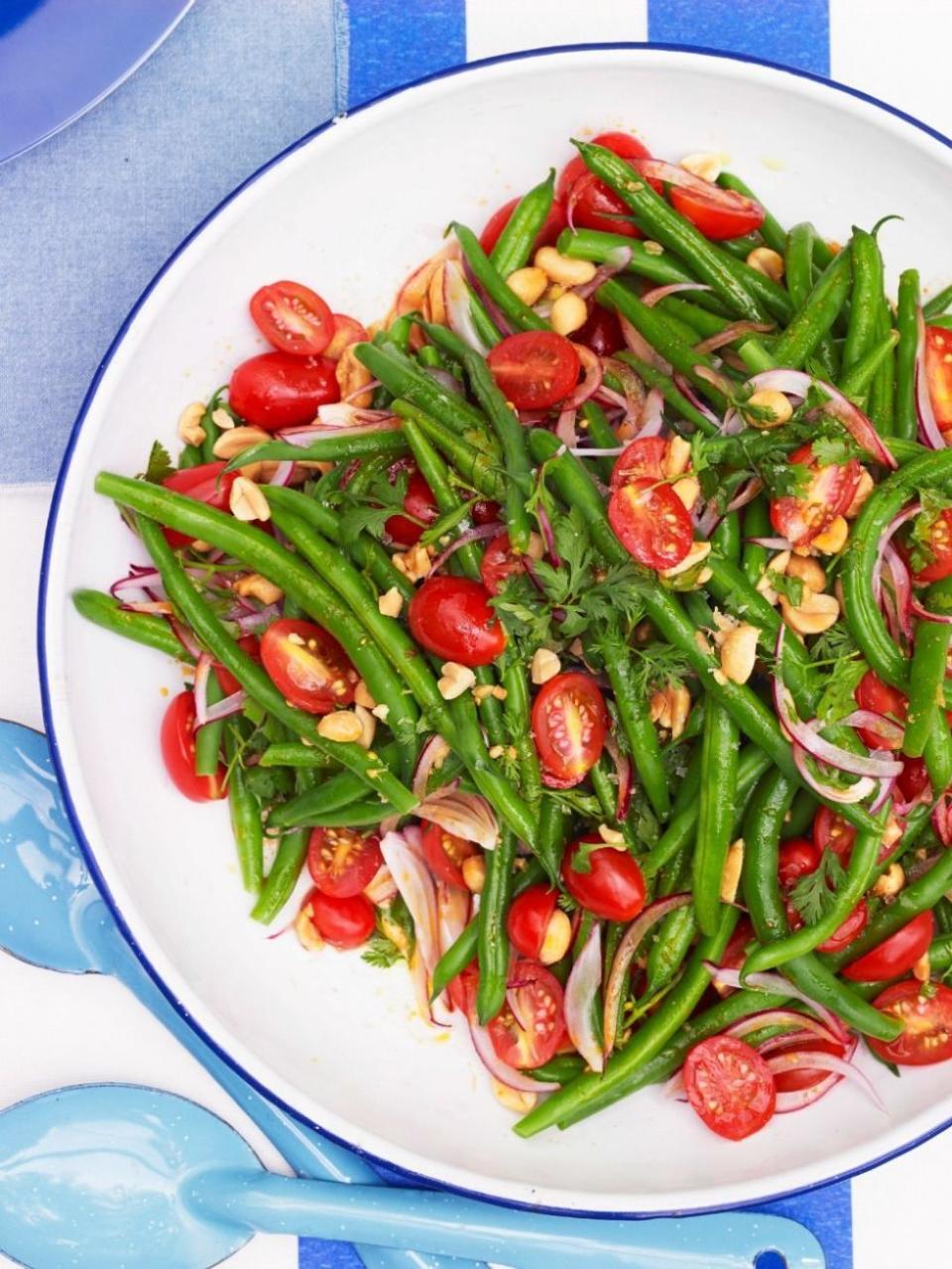 <p>For a light and colorful green bean dish, toss onions, tomatoes, peanuts, and cilantro with green beans before coating with soy sauce, honey, Sriracha, and peanut oil.</p><p>Get the <strong><a href="https://www.womansday.com/food-recipes/food-drinks/recipes/a50976/green-bean-salad/" rel="nofollow noopener" target="_blank" data-ylk="slk:Green Bean Salad recipe;elm:context_link;itc:0;sec:content-canvas" class="link ">Green Bean Salad recipe</a></strong>. </p><p><a class="link " href="https://www.amazon.com/Marukan-Seasoned-Rice-Vinegar-ounce/dp/B00UR6HALY?tag=syn-yahoo-20&ascsubtag=%5Bartid%7C10070.g.2641%5Bsrc%7Cyahoo-us" rel="nofollow noopener" target="_blank" data-ylk="slk:Shop Rice Vinegar;elm:context_link;itc:0;sec:content-canvas">Shop Rice Vinegar</a></p>