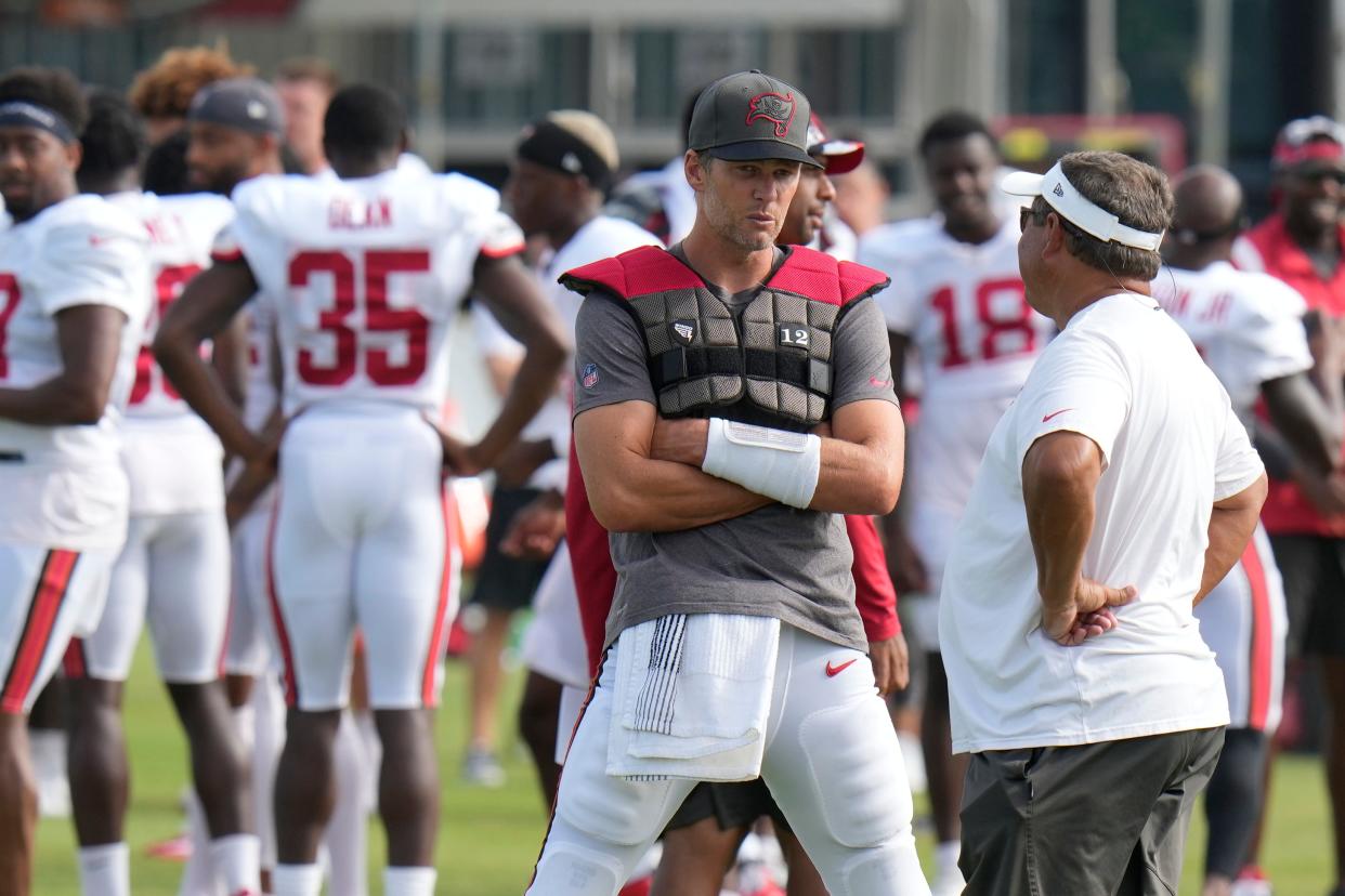 Tampa Bay Buccaneers quarterback Tom Brady with coach Clyde Christensen during an NFL football training camp practice Wednesday, Aug. 10, 2022, in Tampa, Fla. (AP Photo/Chris O'Meara)