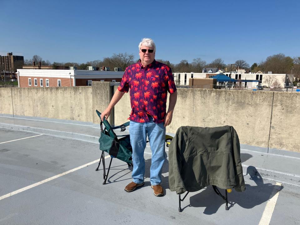 Eric Flanders of Akron's North Hill neighborhood set up lawn chairs atop of one of Cuyahoga Falls’ parking garages at about 10 a.m. for himself, his wife, son and daughter to view the eclipse in the afternoon.