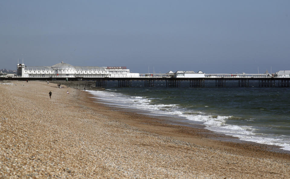 A view of a virtually empty beach in Brighton as the UK continues its lockdown to help curb the spread of coronavirus, in Brighton, England, Saturday April 25, 2020. (Gareth Fuller/PA via AP)