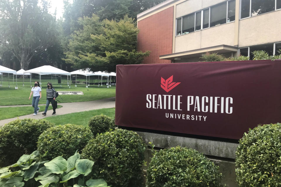 Students walk on the campus of Seattle Pacific University in Seattle on Sunday, Sept. 11, 2022. A group of students, faculty and staff at the Christian university have sued leaders of the board of trustees for refusing to scrap an employment policy barring people in same-sex relationships from full-time jobs at SPU. (AP Photo/Chris Grygiel)