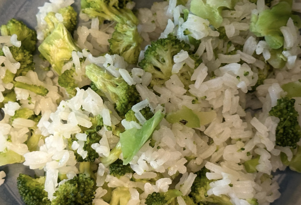 Close-up of broccoli mixed with cooked rice in a bowl