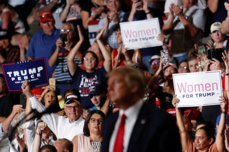 Members of the audience look on as U.S. President Donald Trump delivers remarks at a Keep America Great rally at the Santa Ana Star Center in Rio Rancho, New Mexico