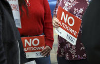 People protest the partial government shutdown in downtown Denver on Thursday, Jan. 10, 2019. Federal workers are scaling back spending, canceling trips, applying for unemployment benefits, seeking second jobs and taking out loans to stay afloat, with no end in sight for a shutdown that enters its 21st day Friday, and will be the longest in history by this weekend. (AP Photo/Thomas Peipert)