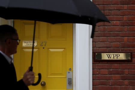 FILE PHOTO: A logo hangs on the wall outside the WPP offices in London, Britain April 30, 2018. REUTERS/Simon Dawson