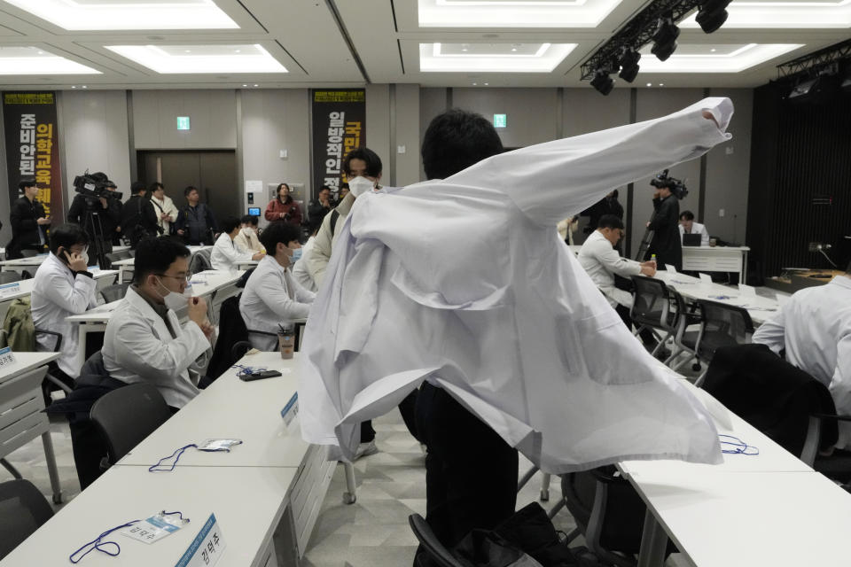 A trainee doctor wears a white gown to attend a meeting at the Korea Medical Association building in Seoul, South Korea, Tuesday, Feb. 20, 2024. South Korean trainee doctors collectively walked off their jobs Tuesday to escalate their protest of a government medical policy, triggering cancellations of surgeries and other medical treatments at hospitals. (AP Photo/Ahn Young-joon)