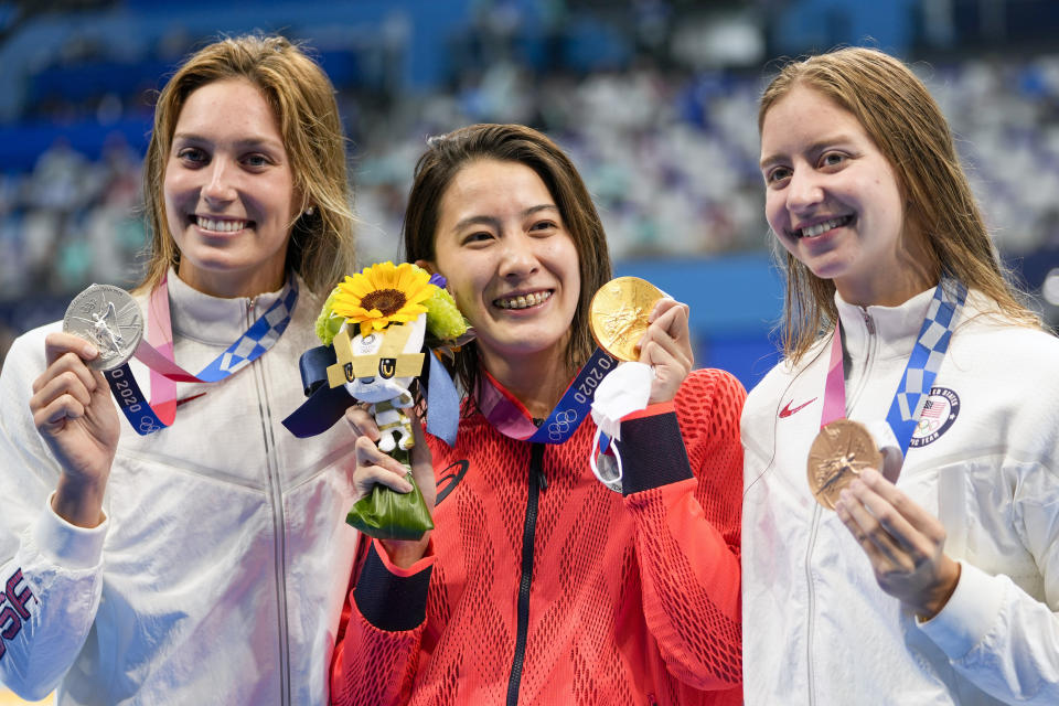 Gold medalist Yui Ohashi, centre, of Japan, stands with silver medalist Alex Walsh of the United States and bronze medalist Kate Douglass, right, of the United States, right, after the women's 200-meter individual medley final at the 2020 Summer Olympics, Wednesday, July 28, 2021, in Tokyo, Japan. (AP Photo/Martin Meissner)