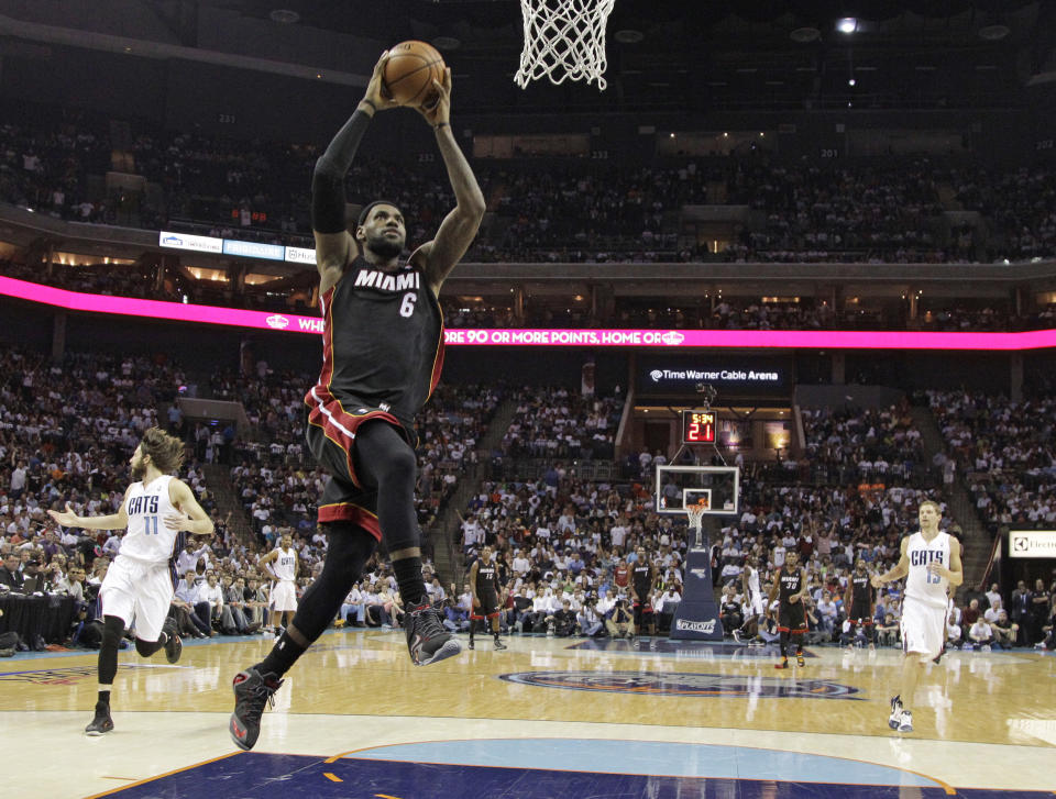 Miami Heat's LeBron James (6) goes up to dunk against the Charlotte Bobcats during the first half in Game 4 of an opening-round NBA basketball playoff series in Charlotte, N.C., Monday, April 28, 2014. (AP Photo/Chuck Burton)