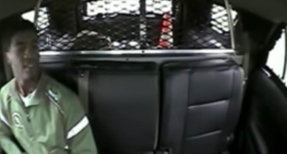 Mr Coleman sits in the back of a police car. Source: YouTube/ The Chronicle Telegram