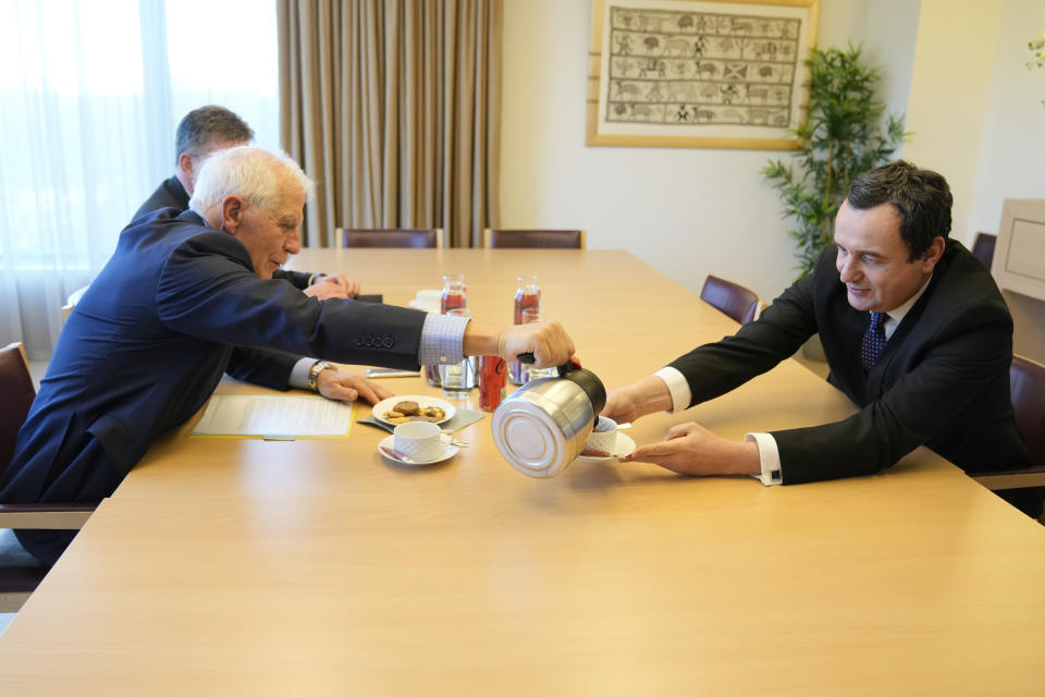 European Union foreign policy chief Josep Borrell, left, pours a cup of coffee for Kosovo's Prime Minister Albin Kurti, right, prior to a meeting in Brussels, Monday, Feb. 27, 2023. The leaders of Serbia and Kosovo are holding talks Monday on European Union proposals aimed at ending a long series of political crises and setting the two on the path to better relations and ultimately mutual recognition. (AP Photo/Virginia Mayo)