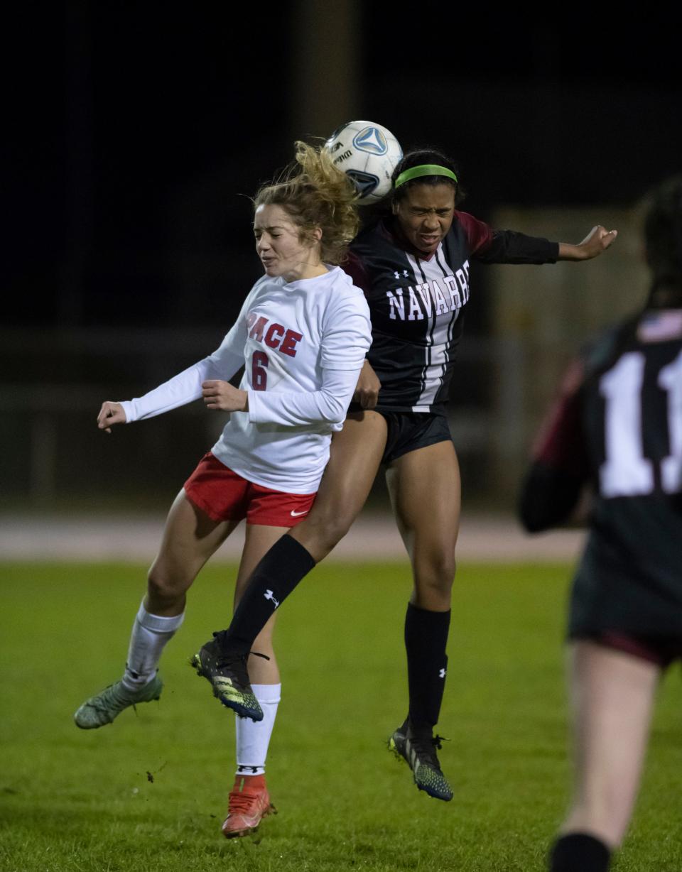 Ava Wheaton (6) and Raegan Young (2) leap to head the ball during the Pace vs Navarre girls soccer game at Navarre High School on Tuesday, Jan. 11, 2022.