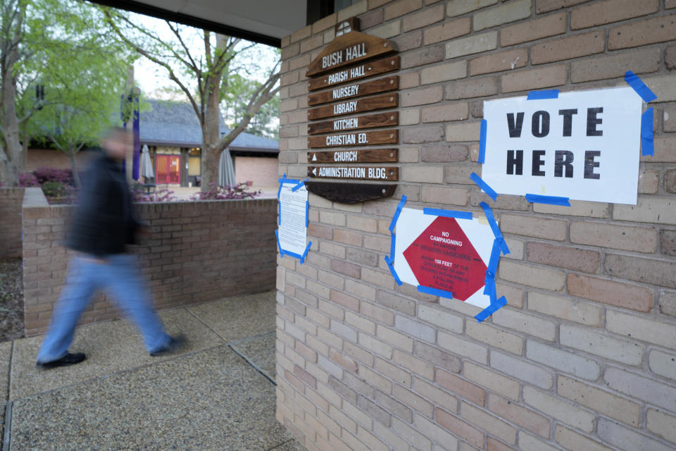 A voter rushes into this north Jackson, Miss., election precinct to cast his ballot during Mississippi's party primaries, Tuesday, March 12, 2024. Mississippians are voting in party primaries for all four of the state's U.S. House seats and one U.S. Senate seat. (AP Photo/Rogelio V. Solis)