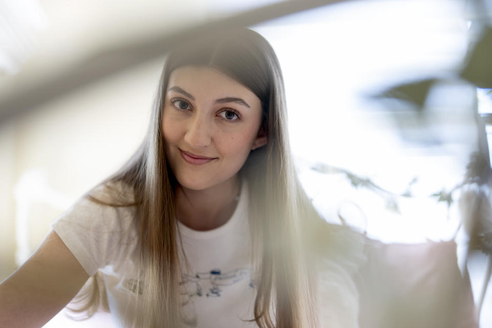 Amea Wadsworth poses for a portrait at her home, Friday, April 19, 2024, in San Diego. Wadsworth, who moved back home after graduating college, wanted to use her first full-time job as a chance to save, and a moment to take a hard look at her spending activity. (AP Photo/Gregory Bull)