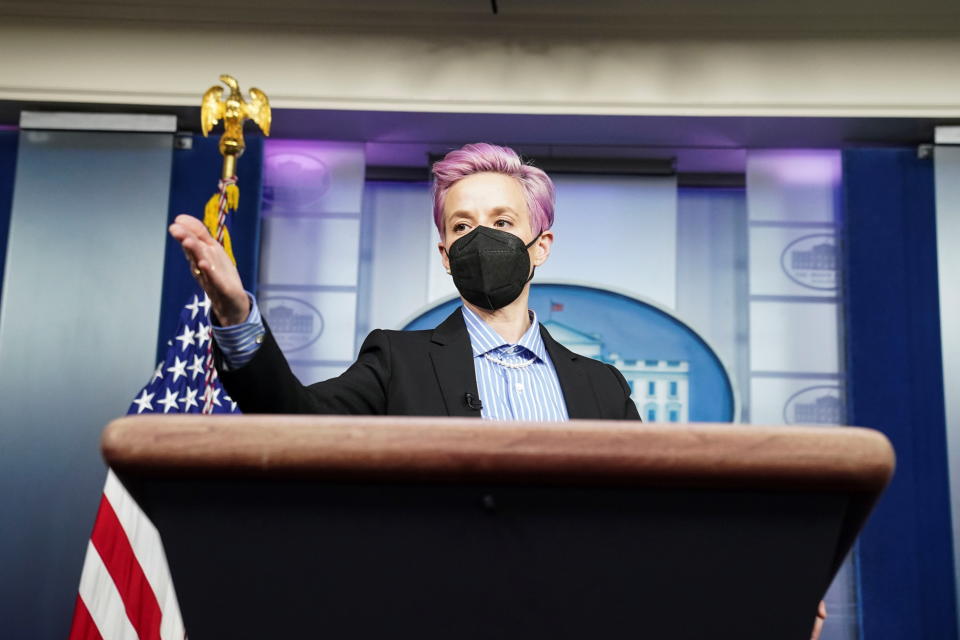 U.S. Women’s National Soccer Team player Megan Rapinoe, visiting Biden administration members on 'Equal Pay Day' symbolic of the gender pay gap, poses for pictures at the lectern in the press briefing room at the White House in Washington, U.S., March 24, 2021. REUTERS/Kevin Lamarque
