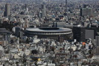 The New National Stadium, a venue for the opening and closing ceremonies at the Tokyo 2020 Olympics, is seen from Shibuya Sky observation deck in Tokyo, Tuesday, March 3, 2020. The Japanese government has indicated it sees the next couple of weeks as crucial to containing the spread of COVID-19, which began in China late last year. (AP Photo/Jae C. Hong)