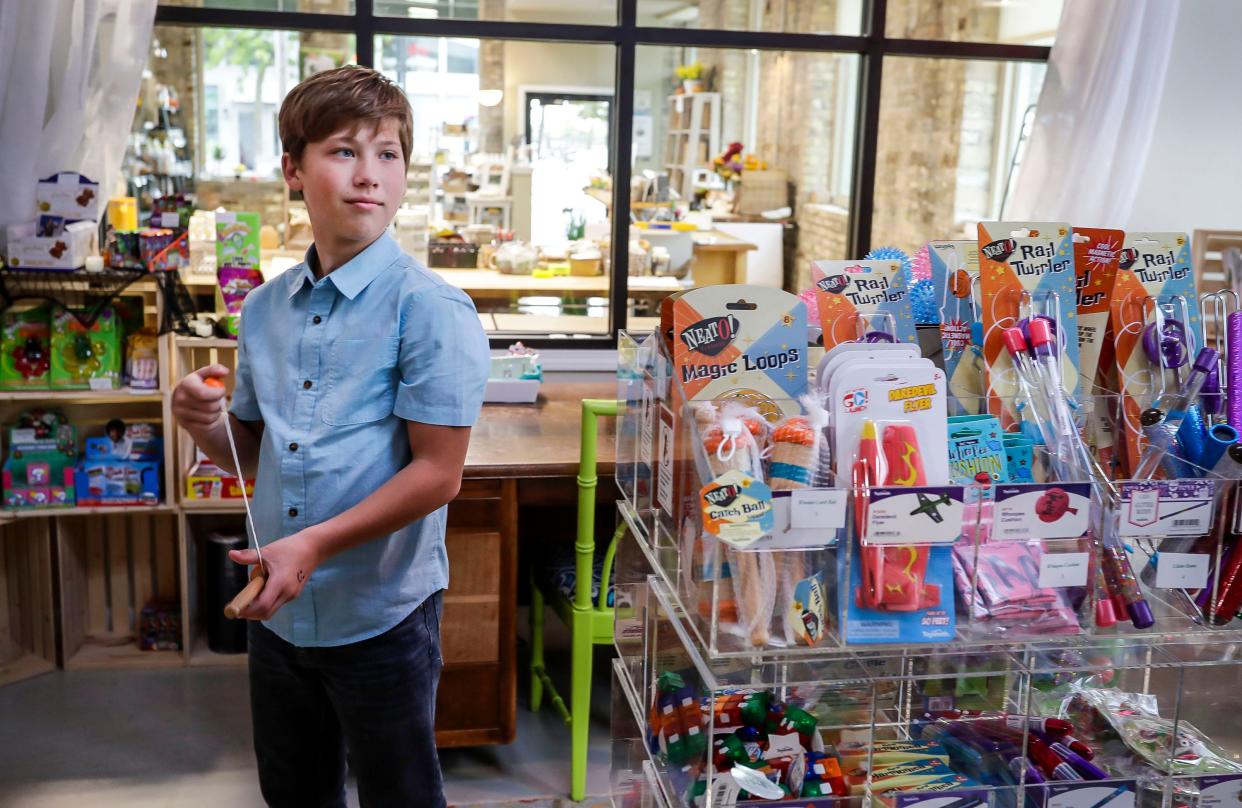 Truman McNitt, 11, listens to a question while he takes a short break from Catch Ball at his store Sugar Twist Trinkets, Wednesday, October 18, 2023, in Sheboygan, Wis. The store, the creation of McNitt is housed inside Olivu 426 in Sheboygan.