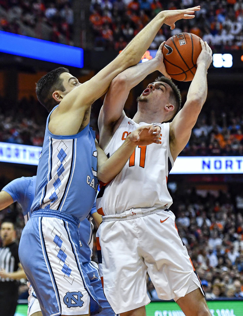 Syracuse guard Joseph Girard III, right, is defended by North Carolina forward Justin Pierce during the second half of an NCAA college basketball game in Syracuse, N.Y., Saturday, Feb. 29, 2020. North Carolina defeated Syracuse 92-79. (AP Photo/Adrian Kraus)