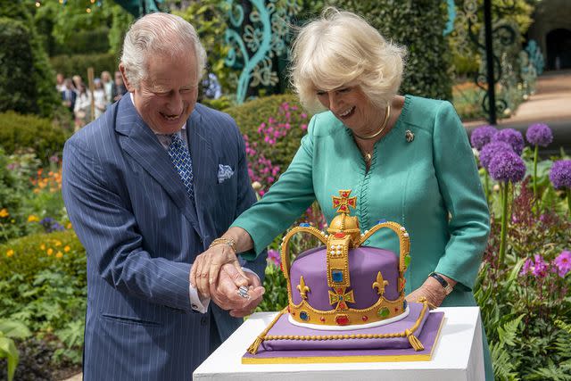 Britain's Prince Charles cuts a birthday cake during a visit to News  Photo - Getty Images