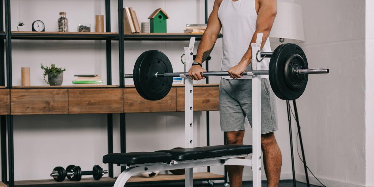 cropped view of man exercising in home gym