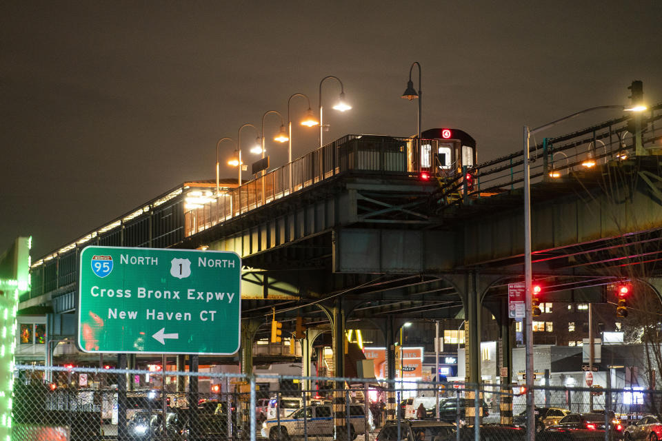 A subway train remains in investigation by police officers after a shooting at the Mount Eden Avenue subway station, Monday, Feb. 12, 2024, in the Bronx borough of New York. (AP Photo/Eduardo Munoz Alvarez)