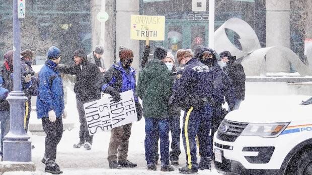 RCMP officers issued tickets and arrested several people at a protest outside Moncton city hall on Jan. 24 for violating the province's emergency measures imposed to limit the spread of COVID-19.  (Guy LeBlanc/Radio-Canada - image credit)