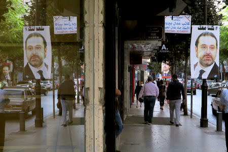 A poster showing Lebanese Prime Minister Saad al-Hariri, who announced his resignation from Saudi Arabia, is seen in Beirut, Lebanon, November 15, 2017. Words on poster reads "We are all with you". REUTERS/Jamal Saidi