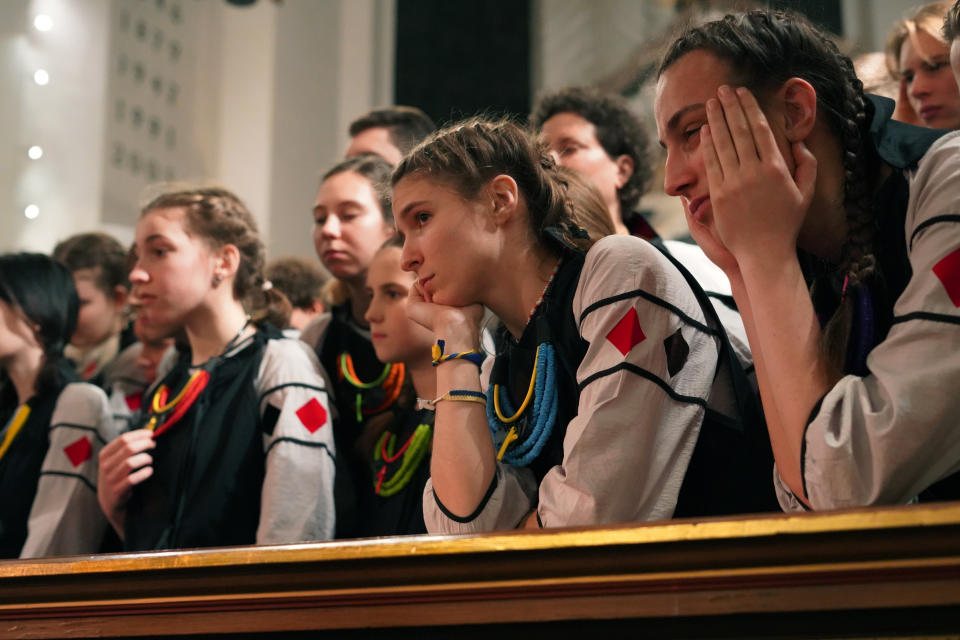 Shchedryk youth choir members listen to chief conductor Marianna Sablina following a Christmas concert at Copenhagen’s Church of the Holy Spirit, in Copenhagen, Denmark, Thursday, Dec. 8 2022. The Shchedryk ensemble, described as Kyiv’s oldest professional children’s choir, were in the Danish capital this week for a performance as part of an international tour that also took them to New York’s famed Carnegie Hall. (AP Photo/James Brooks)